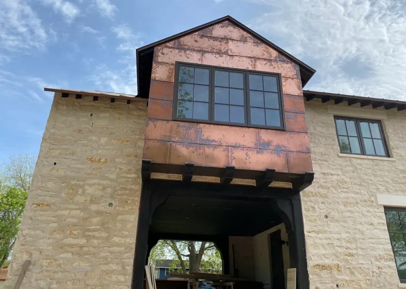 Copper metal panel facade on a stone building for Metal Roof Coating in Hutto
