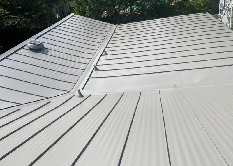 Solar attic fan installed on a metal roof for Roof Ventilation in Hutto